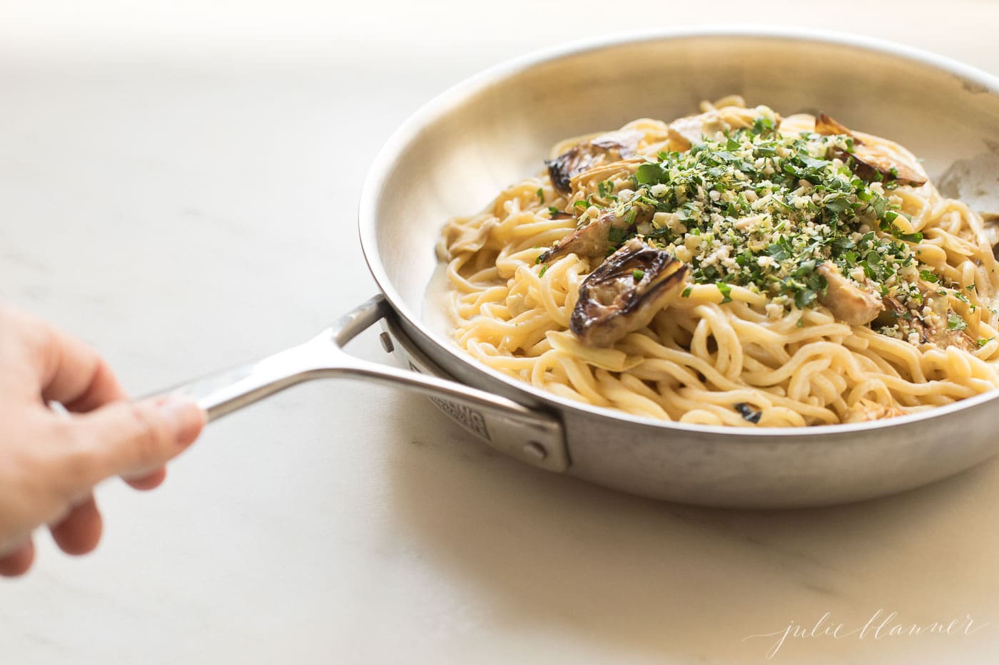 lemon artichoke pasta in a saucepan