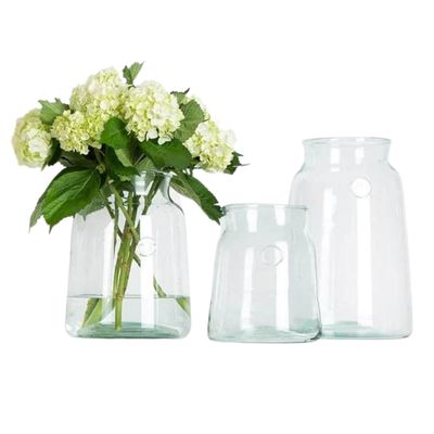 everyday flower vases on a white background, one has stems of green hydrangea. 