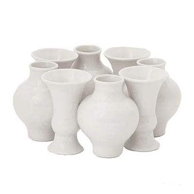 A grouping of white ceramic vases in a circular pattern.