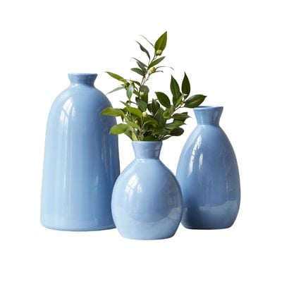 three blue flower vases on a white background.