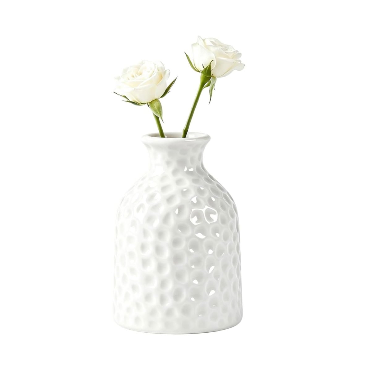 a pair of white honeycomb patterned flower vases with cherry blossom branches in one.