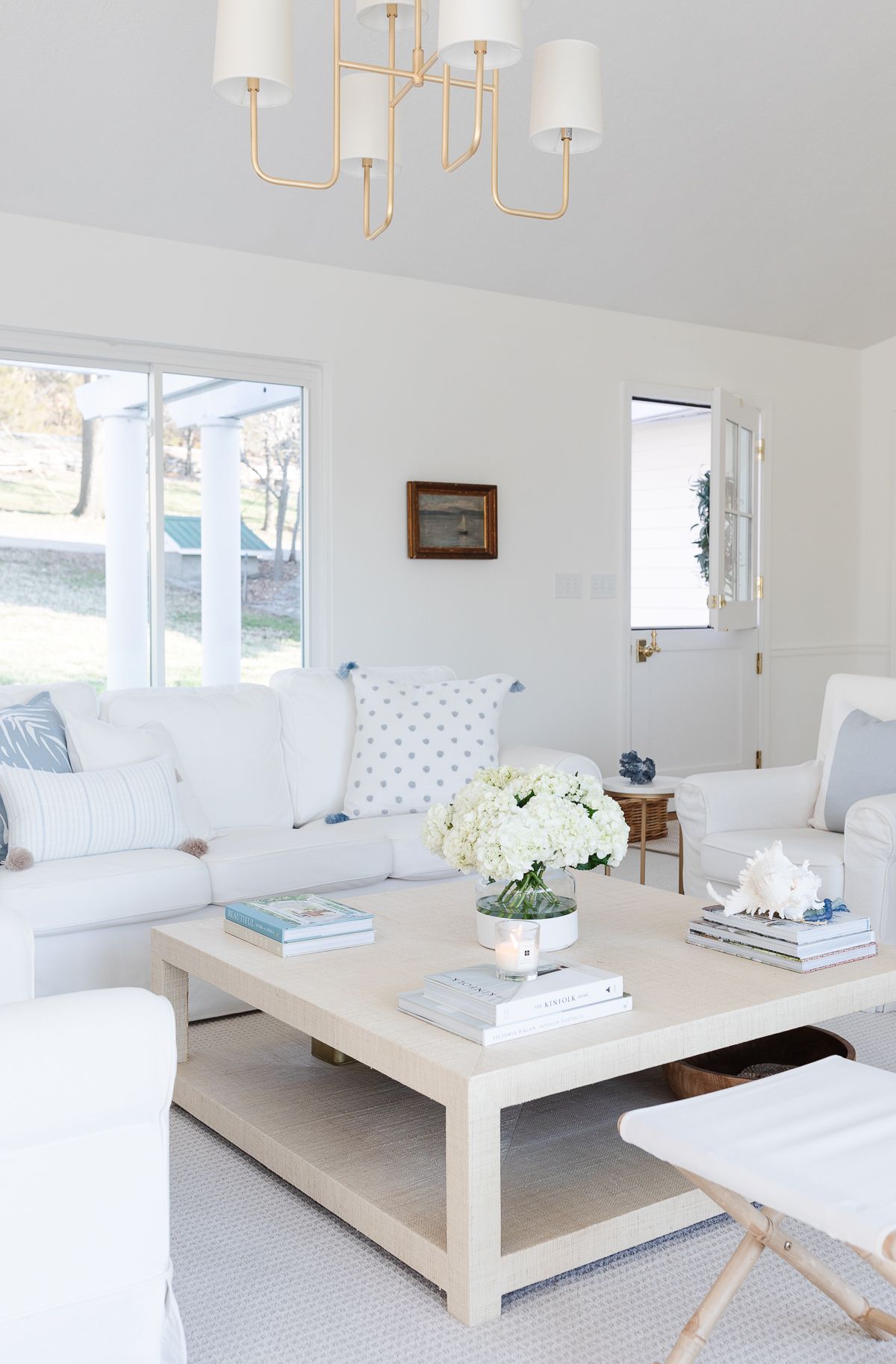 A white living room with white sofas and coastal decor