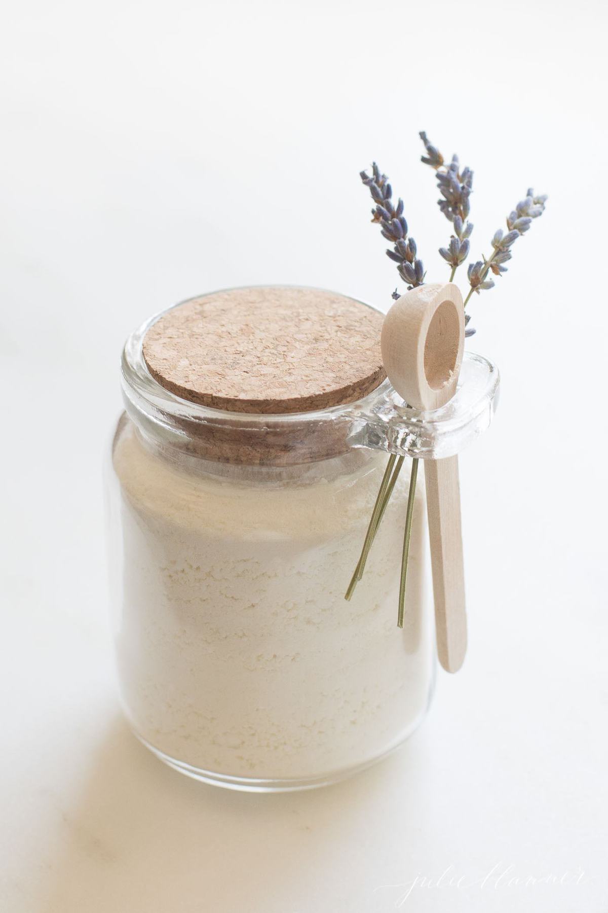 english lavender milk bath in a clear glass bottle.