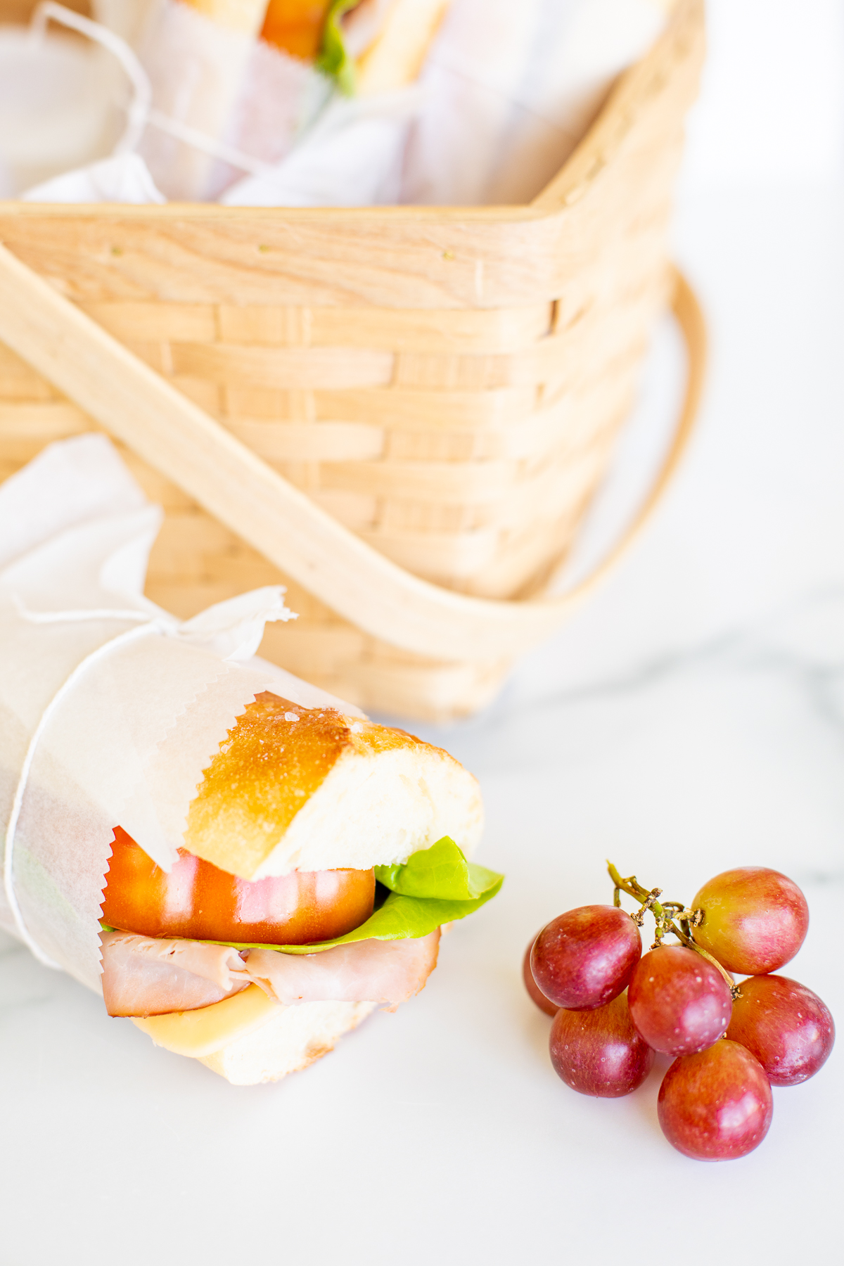 A picnic sandwich with grapes.