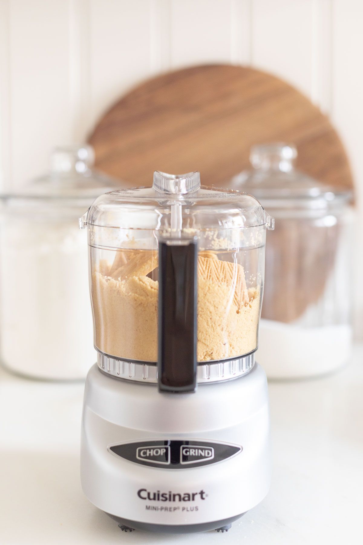 A small food processor filled with shortbread crust ingredients