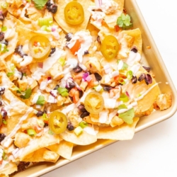 Chicken nachos on a sheet pan.