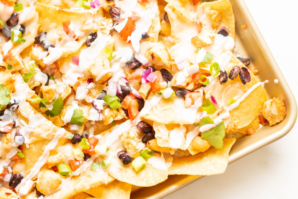 Chicken nachos on a sheet pan.