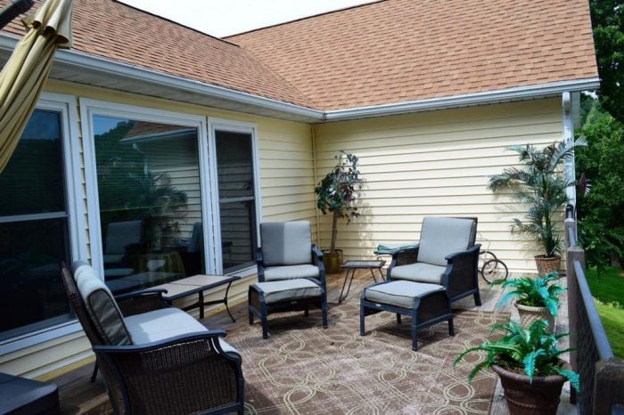 deck with patio furniture yellow house orange roof