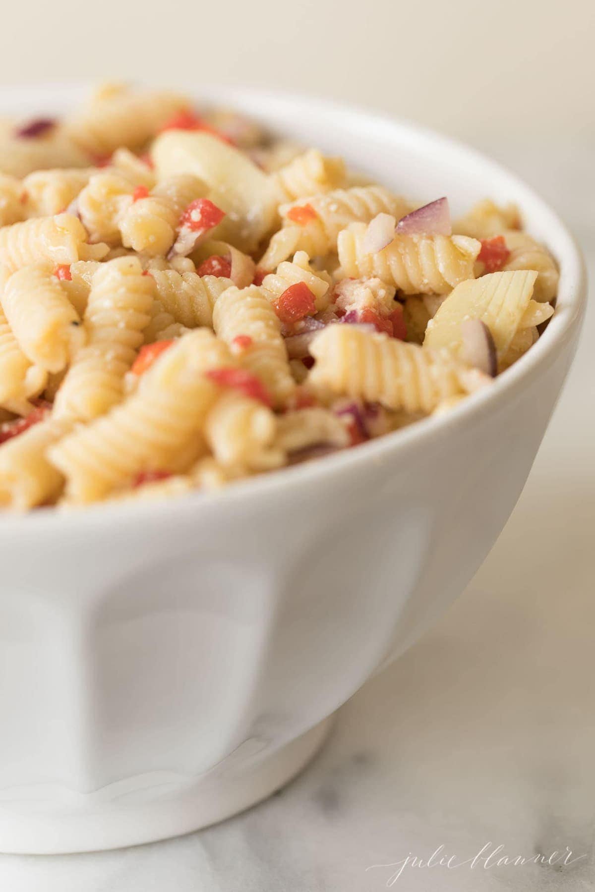 italian pasta salad served in a white bowl