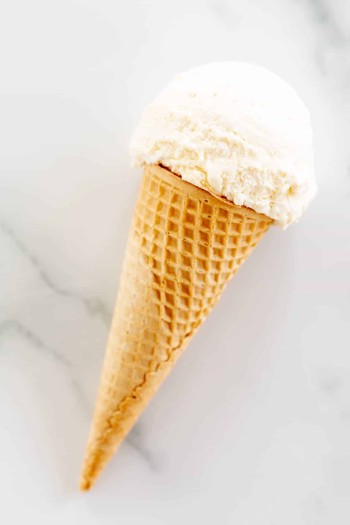 marshmallow ice cream in cone on marble surface