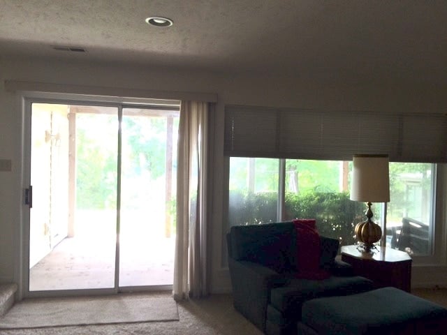 Living room before being remodeled, cream walls and brown carpet. 