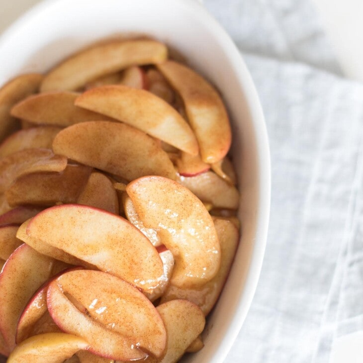 baked apple slices in white casserole dish
