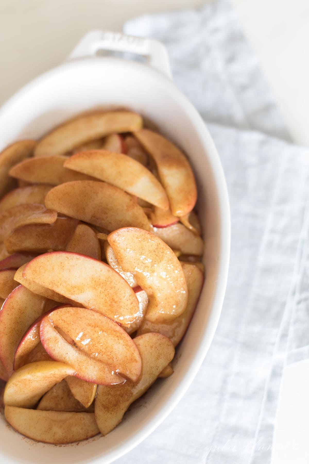 baked apple slices in white casserole dish