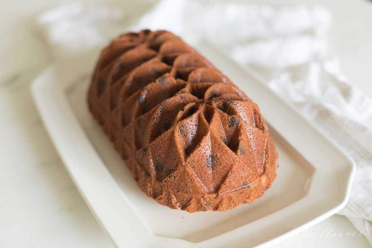 chocolate chip pound cake shaped in a decorative loaf, on a white platter
