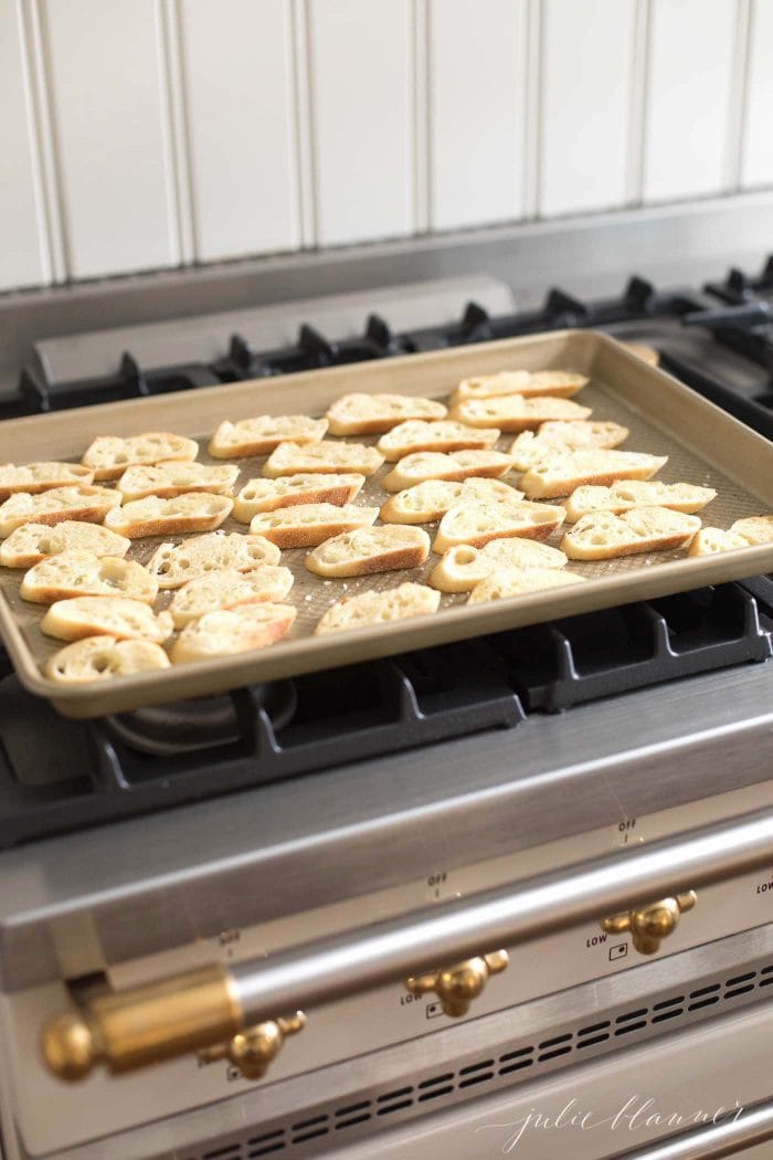 Crostini isn't available in every grocery store and it can be expensive, but it's so easy to make using fresh or even slightly stale baguette. Crostini are the perfect accompaniment to cheese trays and appetizers, and can be enjoyed alone or topped with fruits, veggies, meat and herbs. #crostini #appetizer