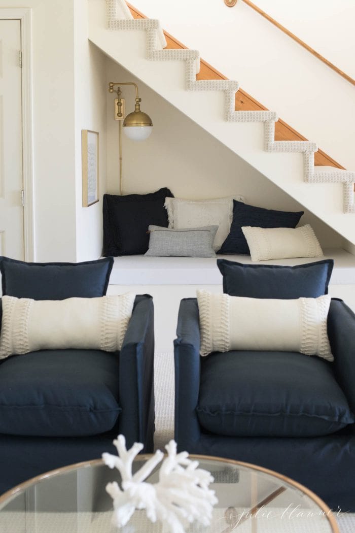 A modern living room with navy and cream accents. 