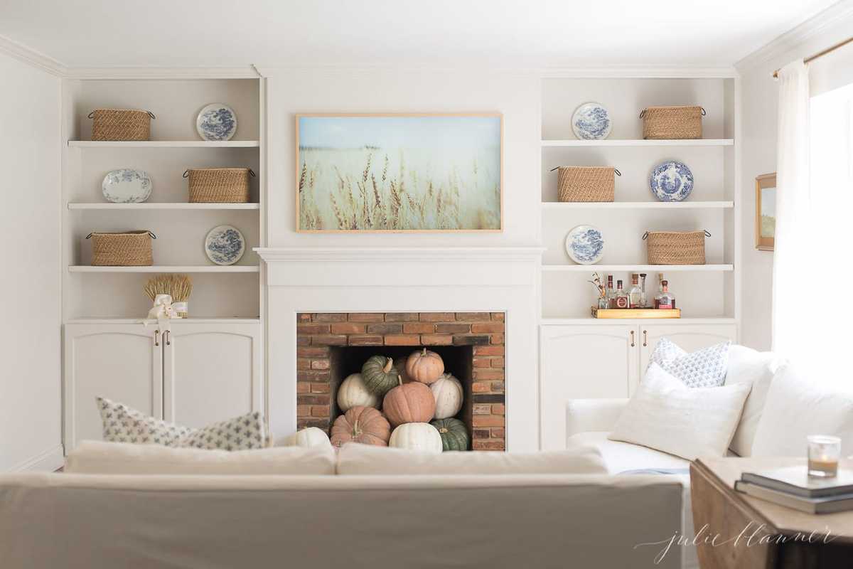 A white living room decorated for fall