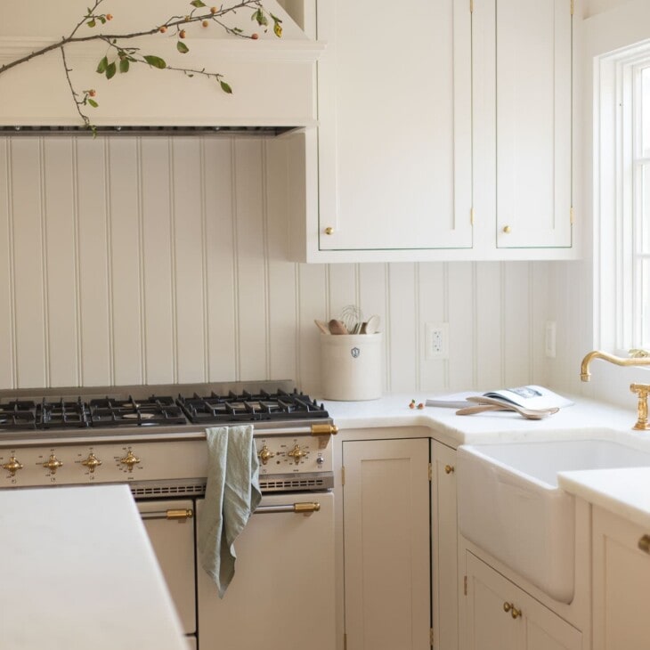 cream kitchen with crabapple branch on range hood