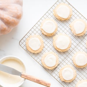 A stack of pumpkin spice sugar cookies with a cream cheese glaze.