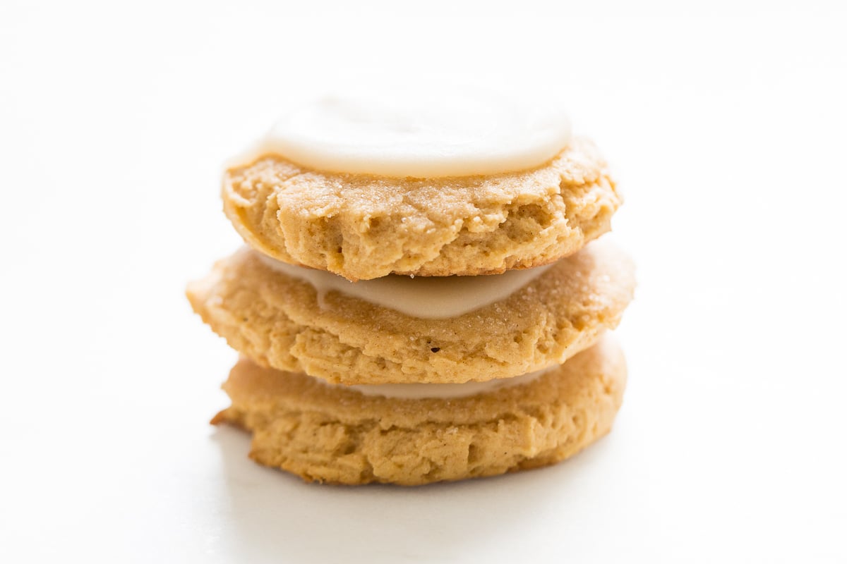 A stack of pumpkin spice sugar cookies with a cream cheese glaze.