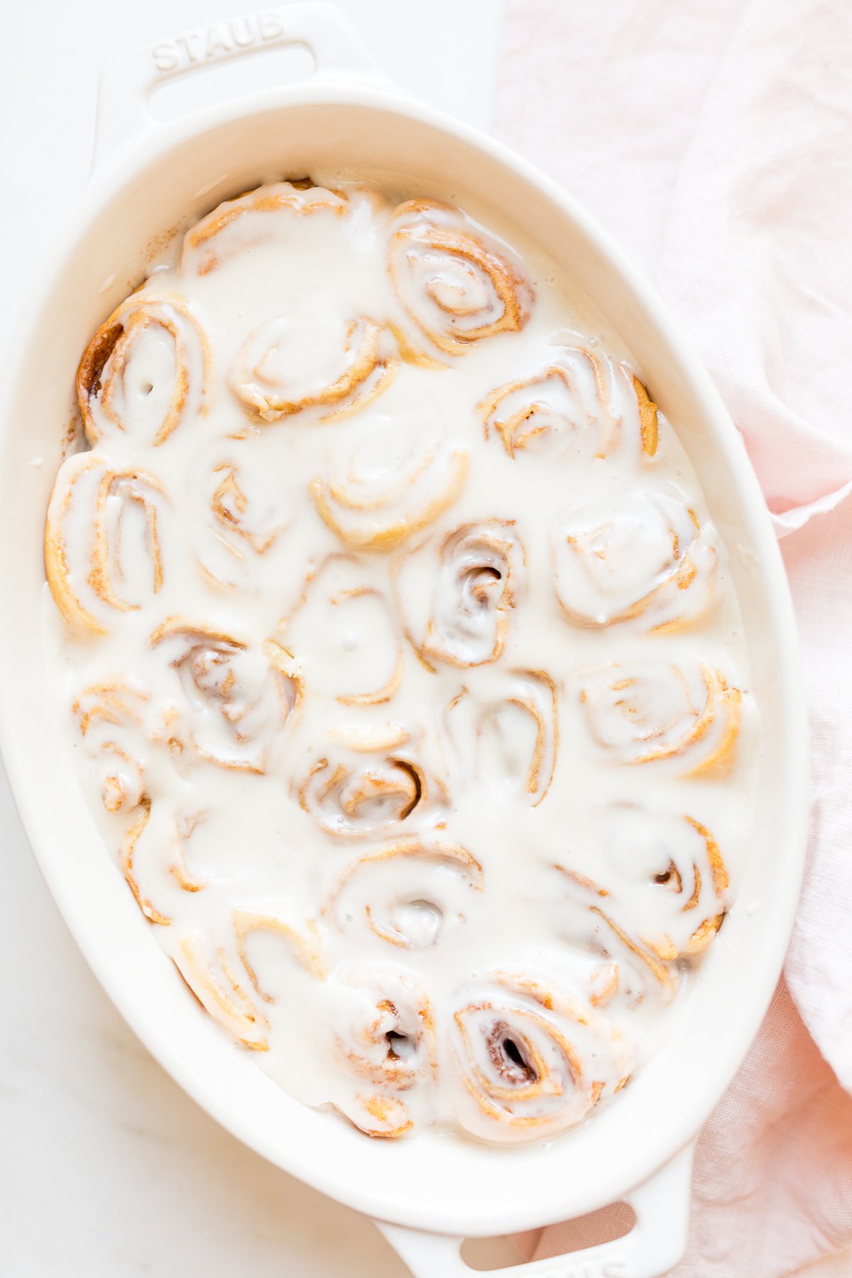 Cinnamon rolls made with crescent rolls in a white oval dish. 