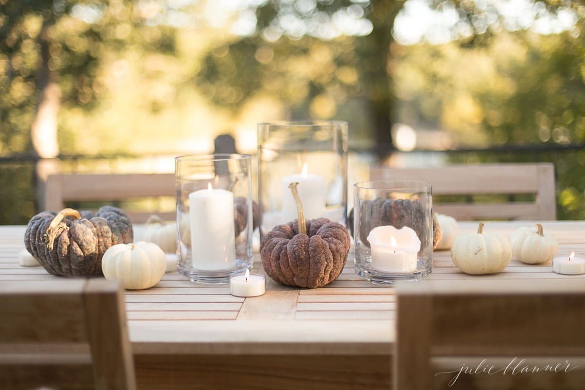 pumpkins and candles on table