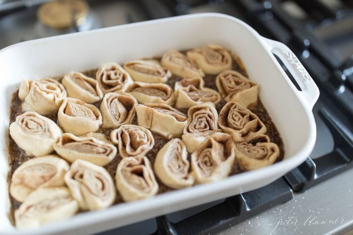 Pecan rolls placed in the butter