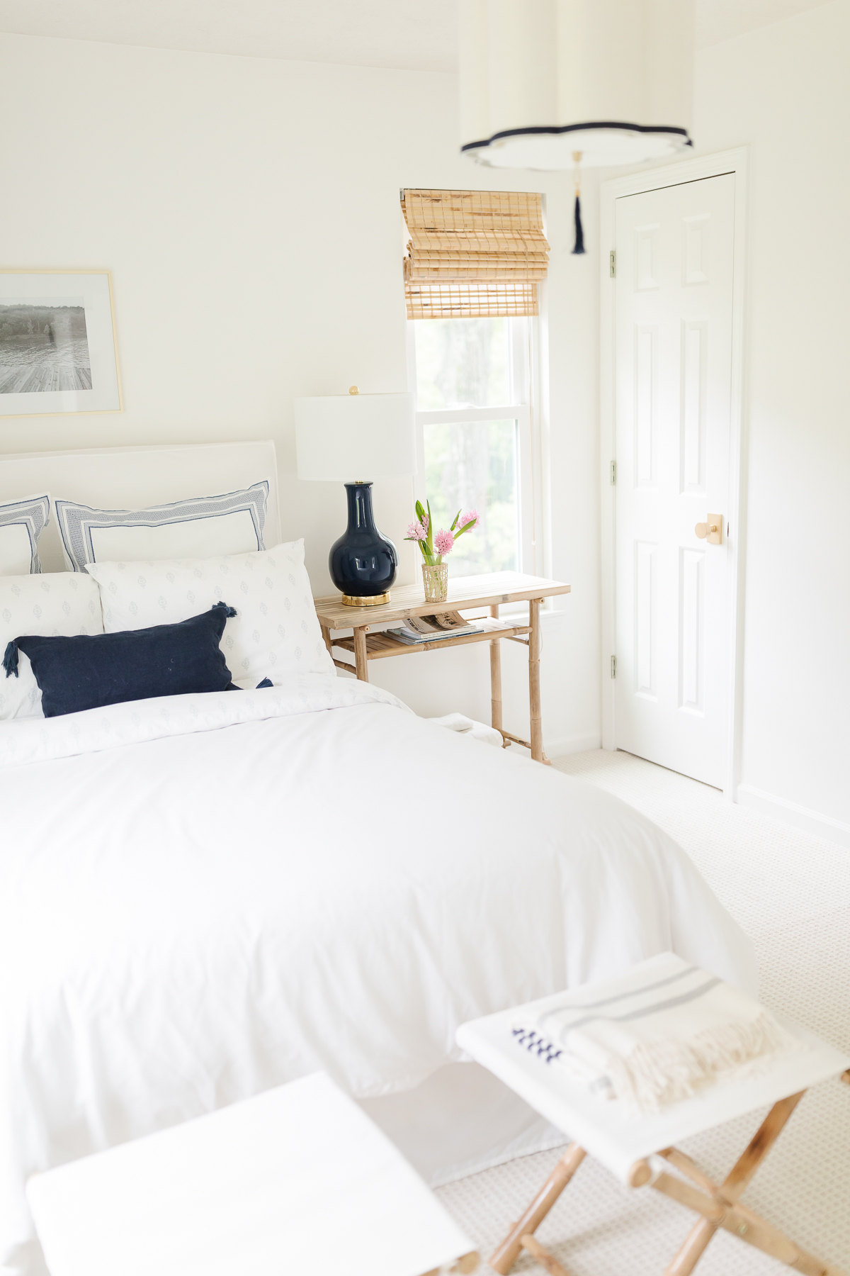 A white bed in a small bedroom.