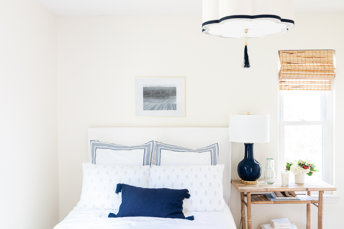 A white bedroom with a bed and a lamp, perfect for small bedroom decor.