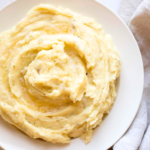 caramelized onion mashed potatoes in a white bowl