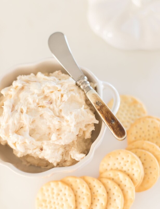 caramelized shallot dip in a white bowl, crackers to the side