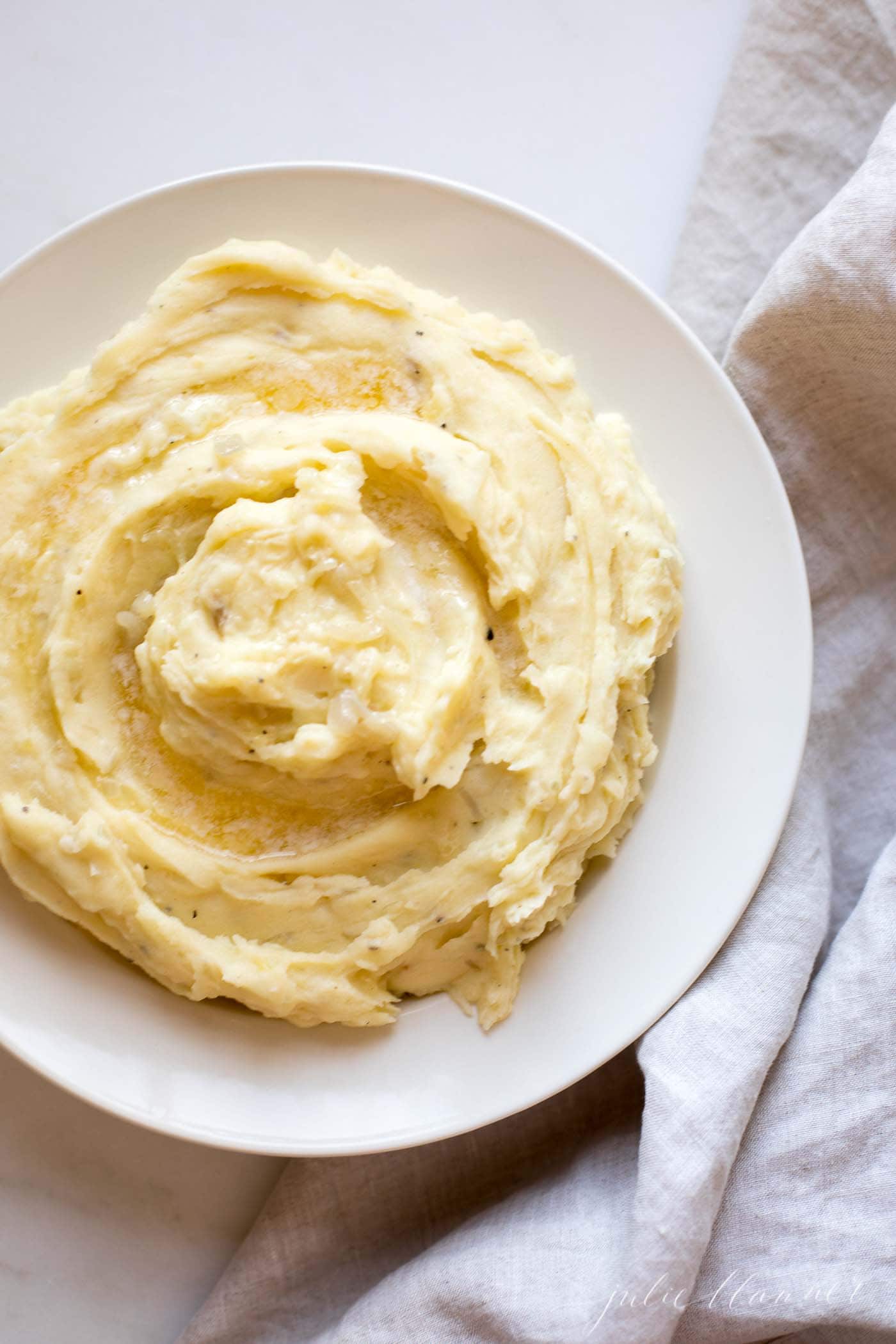 caramelized shallot mashed potatoes on white plate with blue napkin