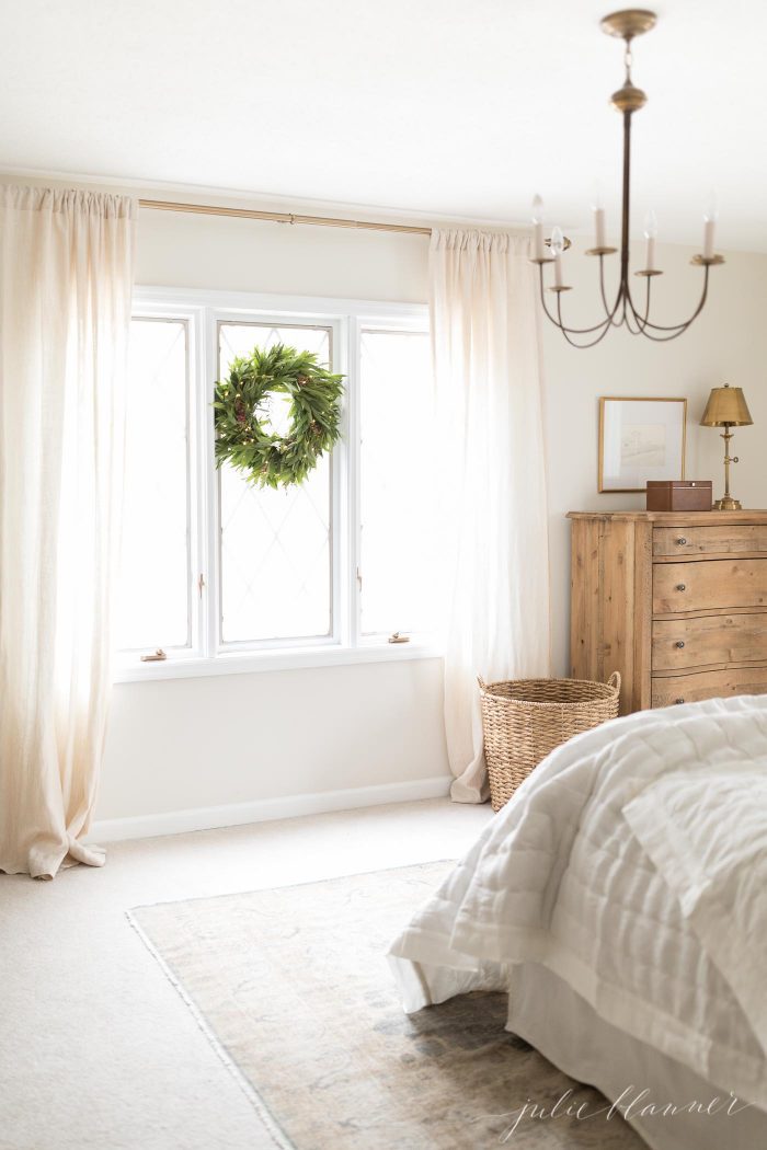 bedroom with wreath in the window