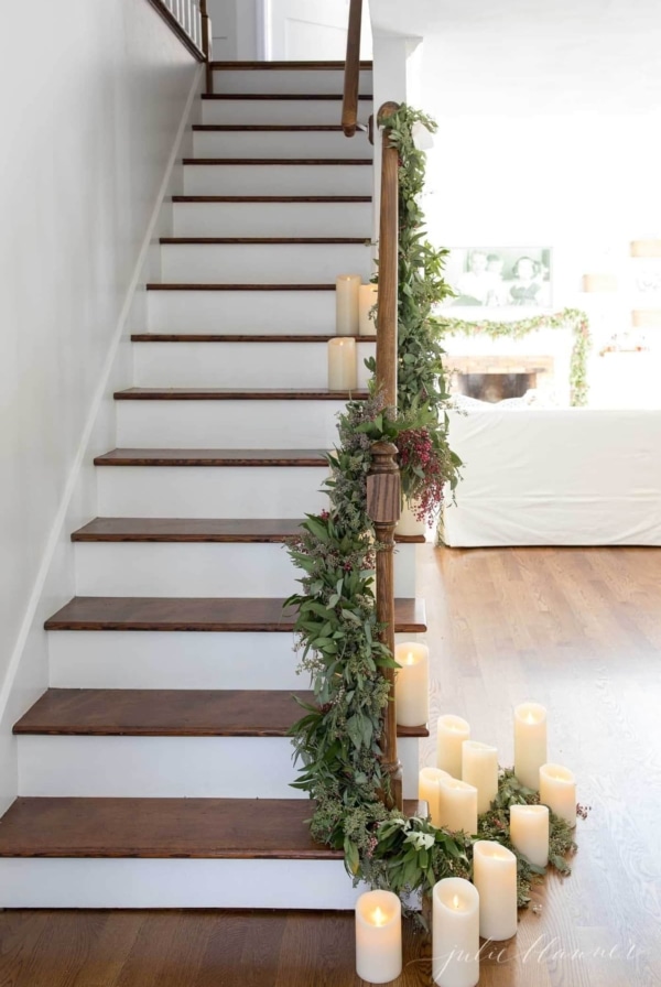 greenery garland on stairs made of fresh christmas greens