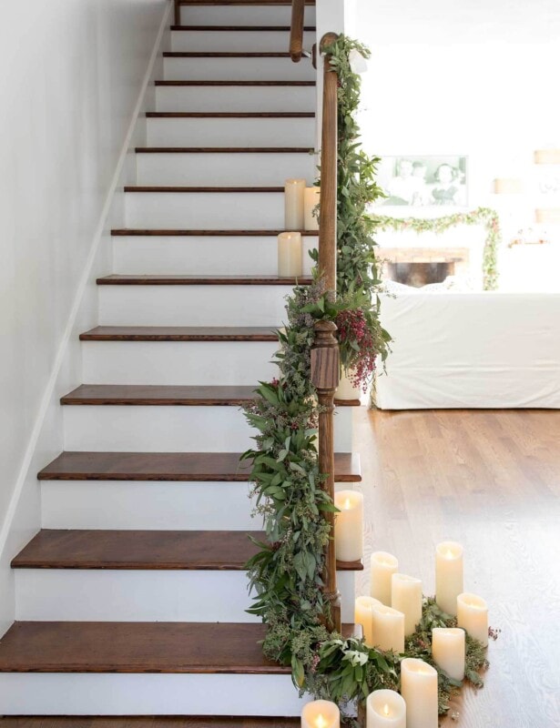 greenery garland on stairs made of fresh christmas greens