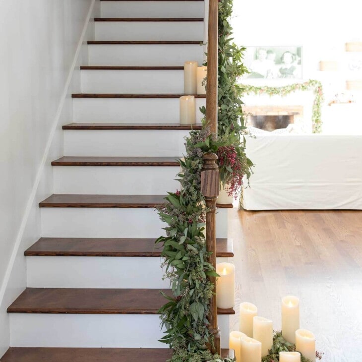 greenery garland on stairs made of fresh christmas greens