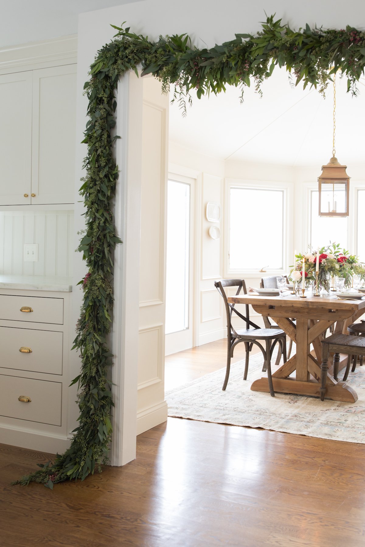 A Christmas garland adorns the dining room of a festive house.