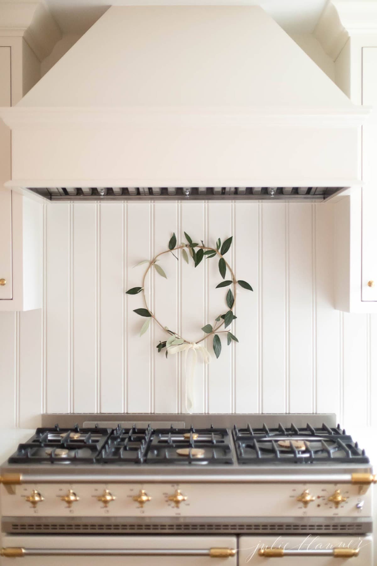 wreath above range in cream kitchen