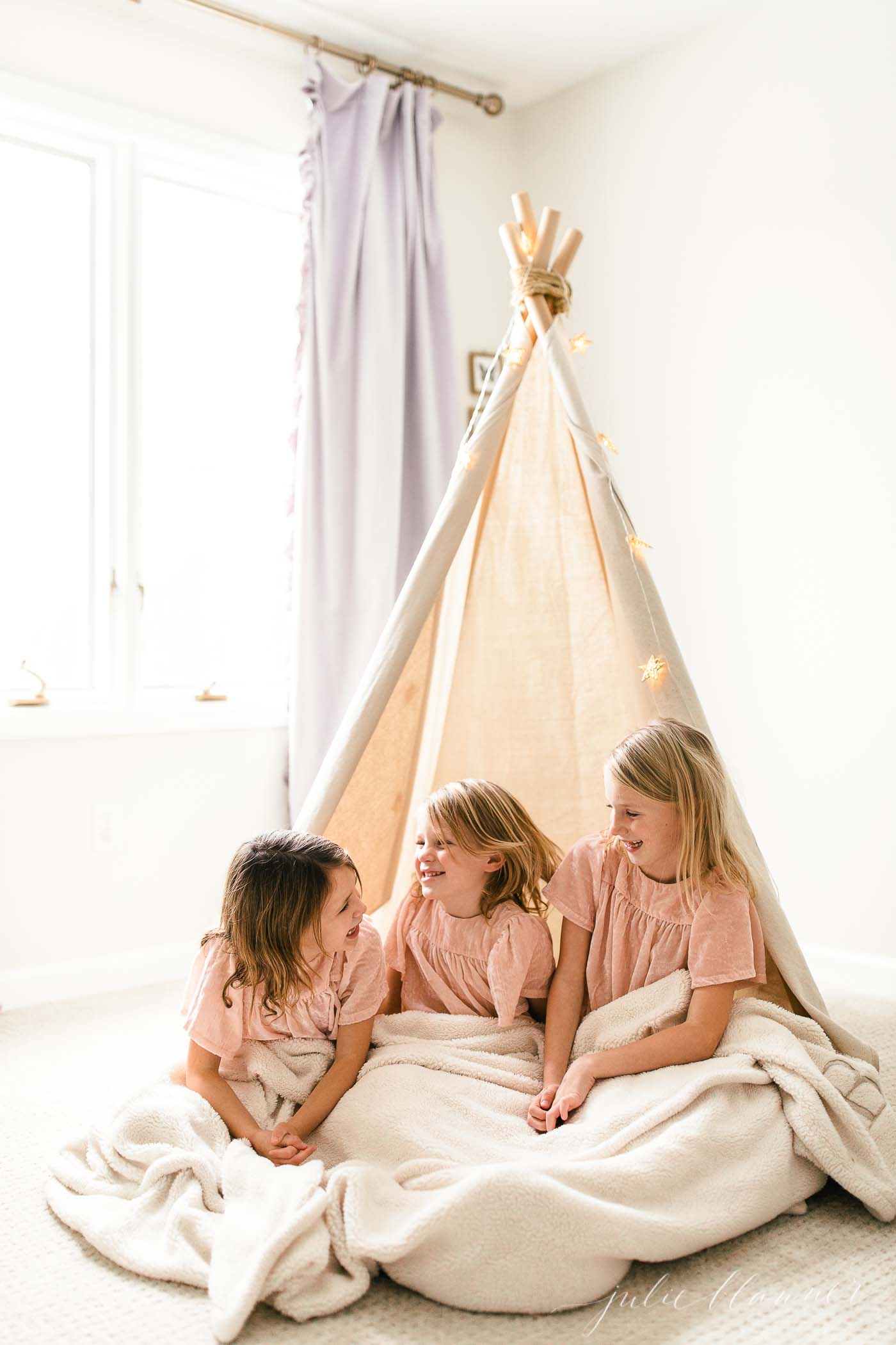 three little girls in a diy teepee tent