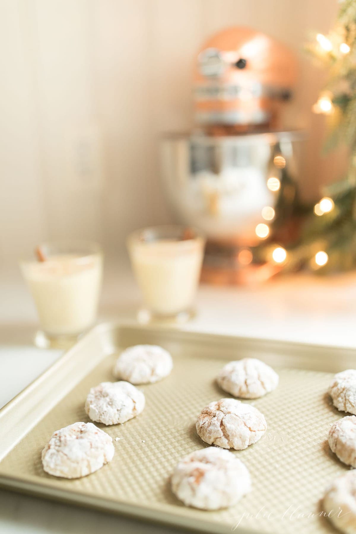 gooey butter eggnog cookies on a baking sheet in a kitchen