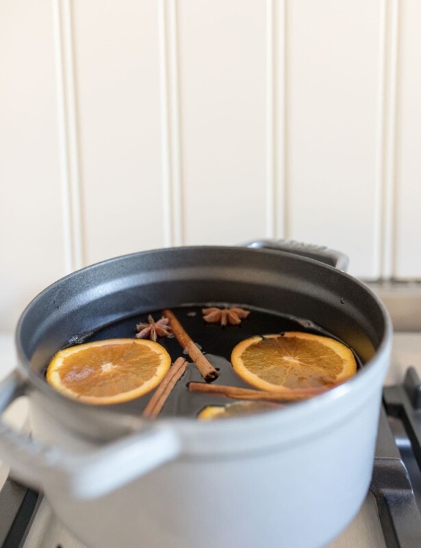 non alcoholic mulled wine recipe in a gray dutch oven on the stovetop