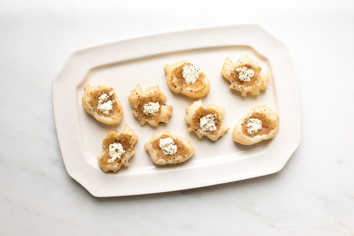 bite sized onion tarts on a platter