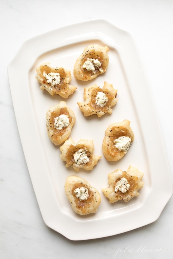 onion tarts on a white tray, shaped into fall leaves