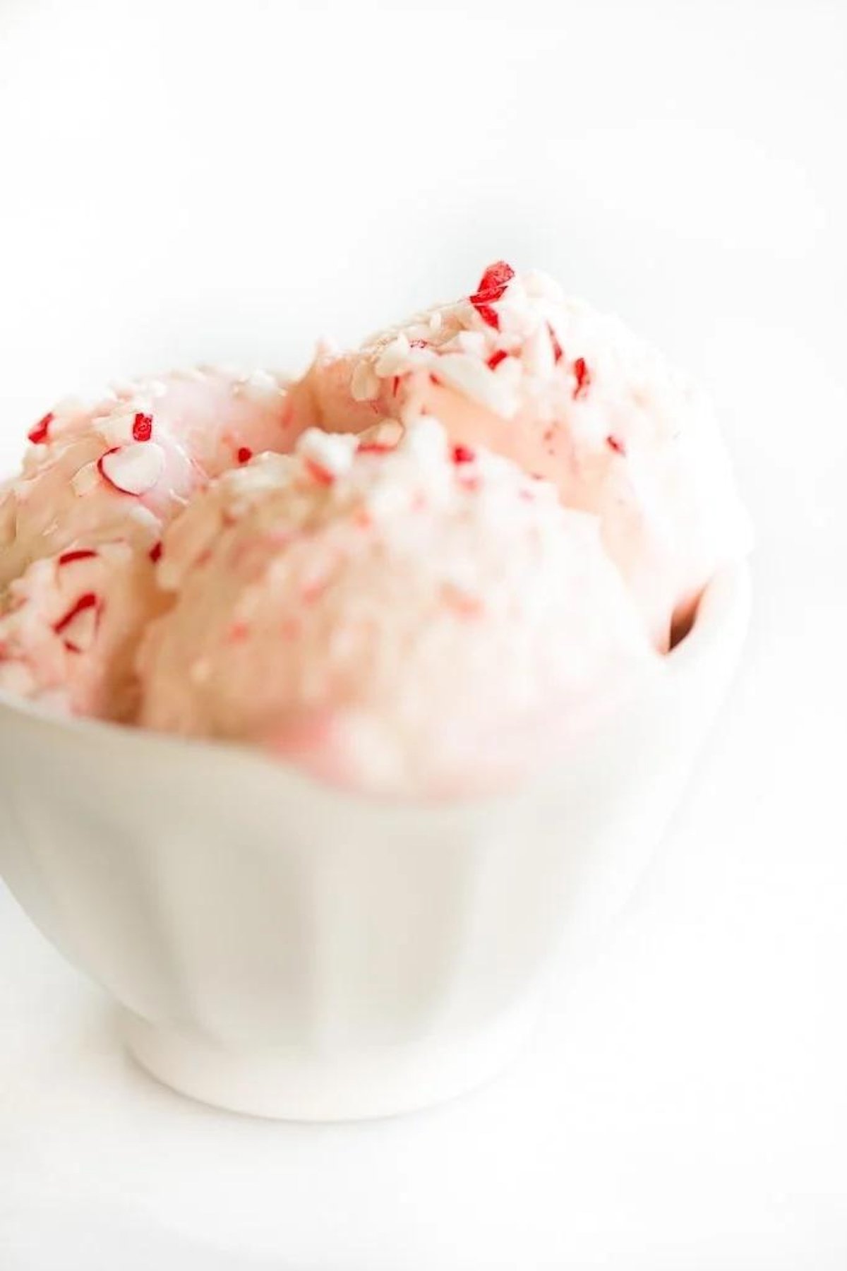 Peppermint stick ice cream in a white bowl.