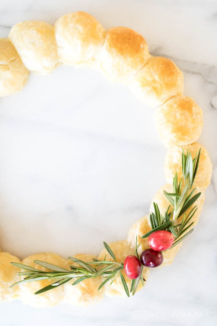 Brie Wreath Christmas Appetizer on a marble work surface