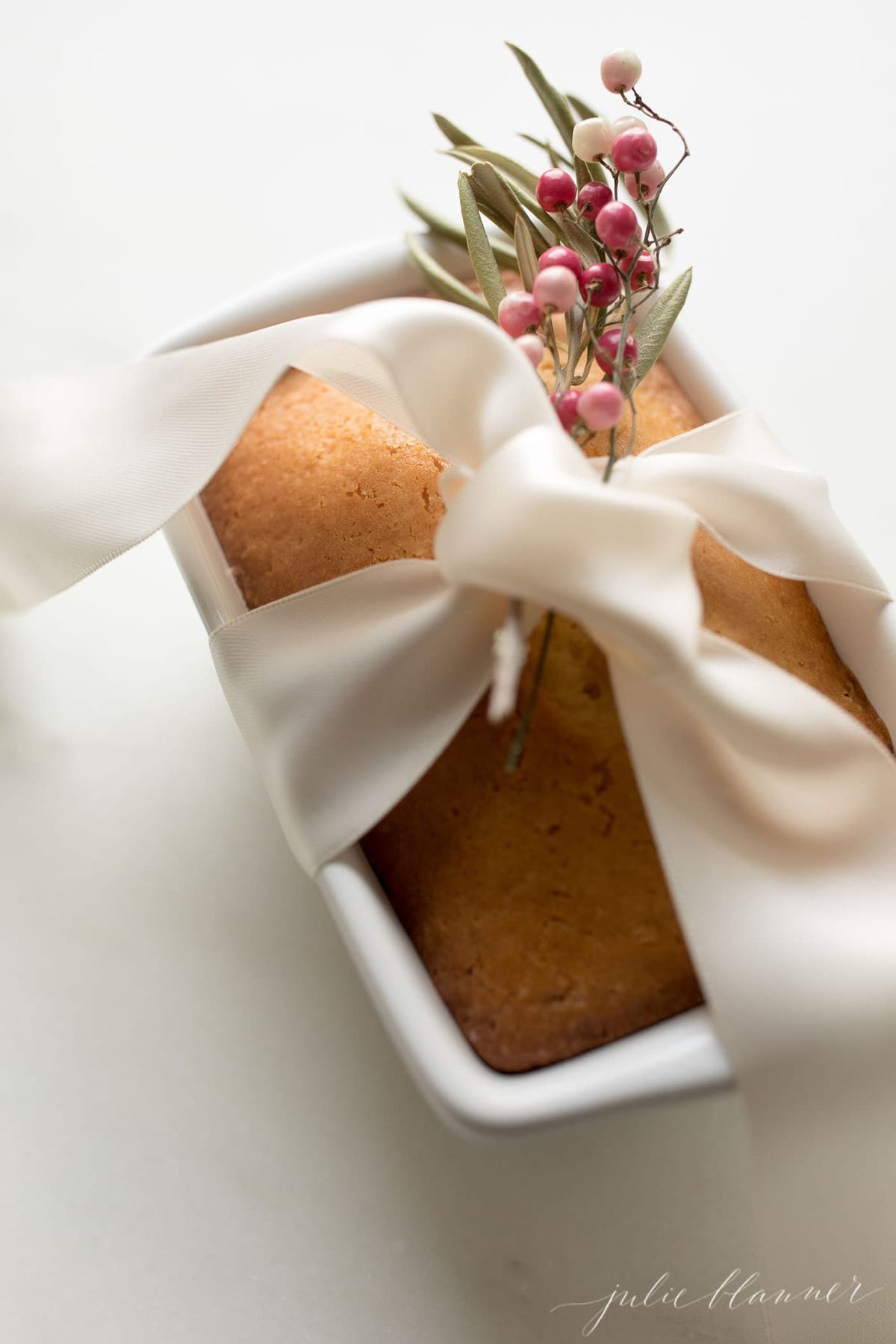 Almond Bread is an incredibly moist, incredibly easy no yeast quick bread made with just a few staple ingredients in 5 minutes! #bread #gift #christmas #christmasgift almond bread wrapped in ribbon