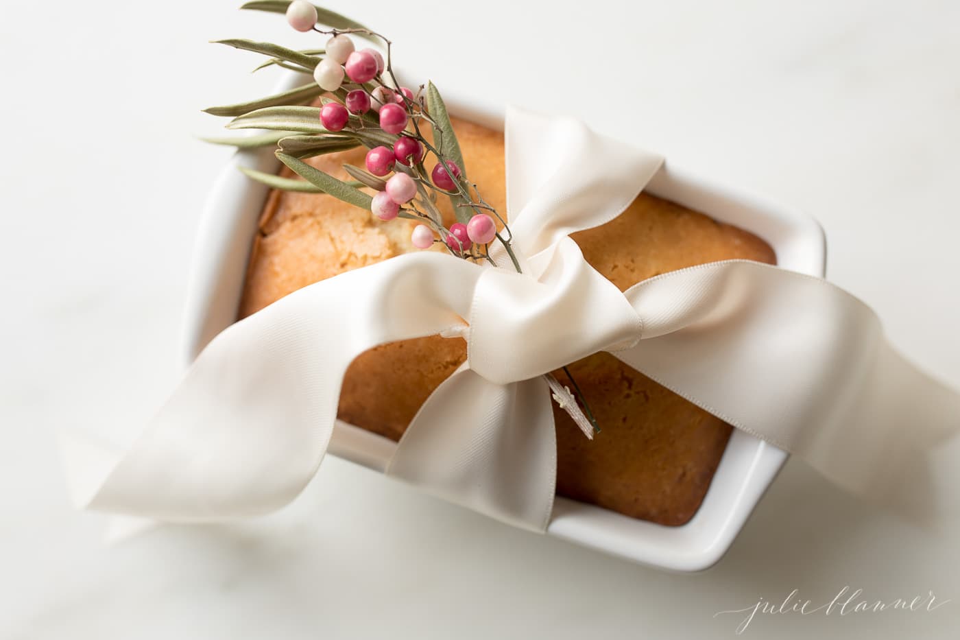 Almond Bread is an incredibly moist, incredibly easy no yeast quick bread made with just a few staple ingredients in 5 minutes! #bread #gift #christmas #christmasgift bread wrapped with ribbon