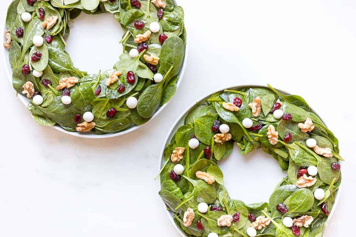 2 christmas wreath salads on white platters