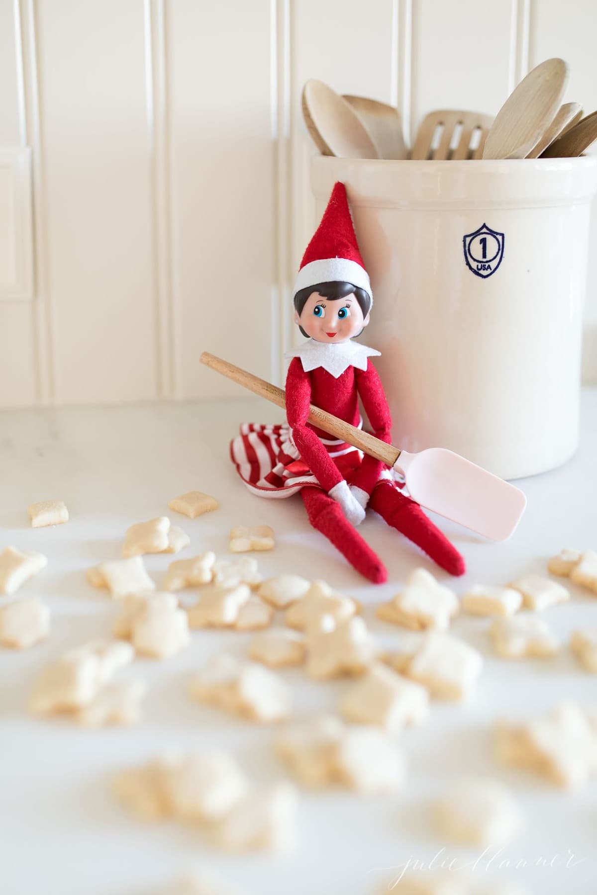 ELF COOKIES are the perfect treat for your elf on the shelf to give your children or for them to bake your elf. Get the easy recipe using just staple ingredients! #elfontheshelf #christmas #christmascookies #cookies #easyrecipe #recipes An elf on the shelf next to mini cookies