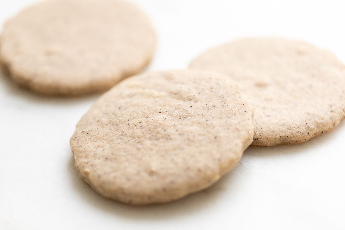Espresso cookies on a white surface.